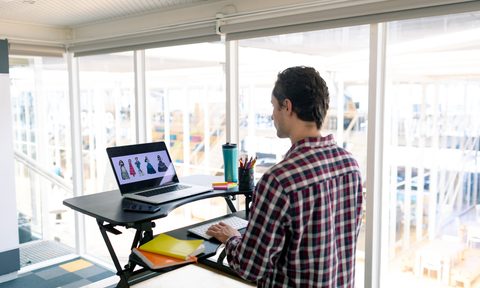 aop version 2 male graphic designer working on laptop at desk