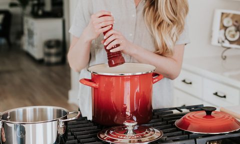 the best pasta pots with a strainer pot woman using pepper mill over