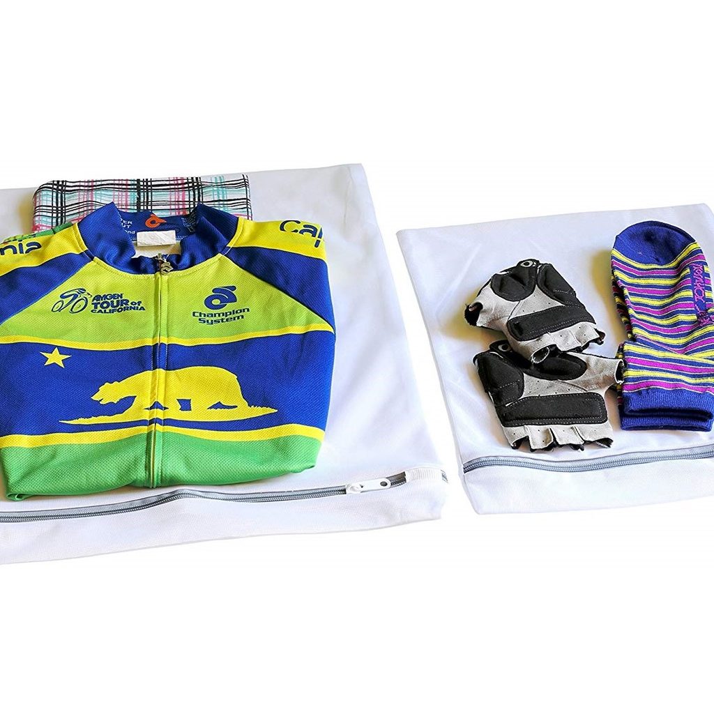 Two SimpleHouseware Laundry Wash Bags with clothes folded on top of them.