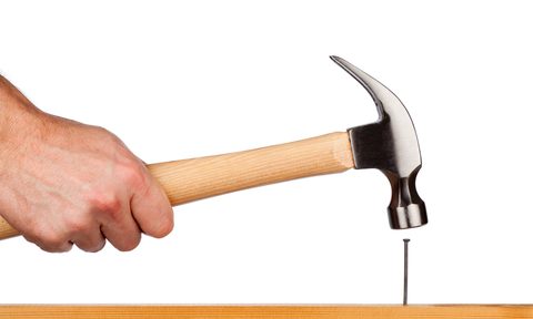 the best short extension cords for your home a hand holding hammer ready to nail