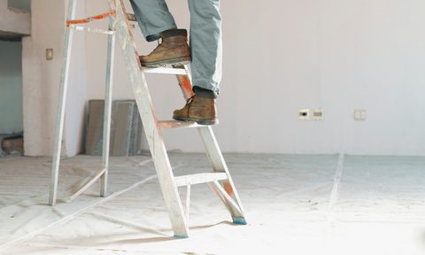 the best ladders for your home man climbing ladder in unfinished room