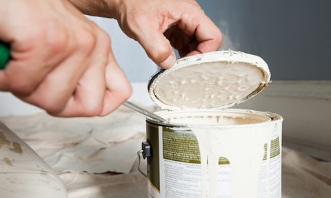 person opening paint can