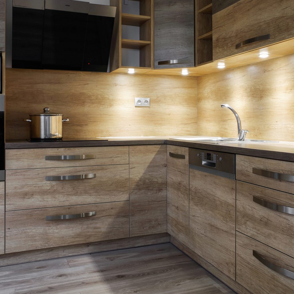modern kitchen with wood cabinets and under cabinet lights
