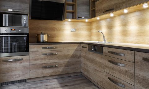 modern kitchen with wood cabinets and under cabinet lights