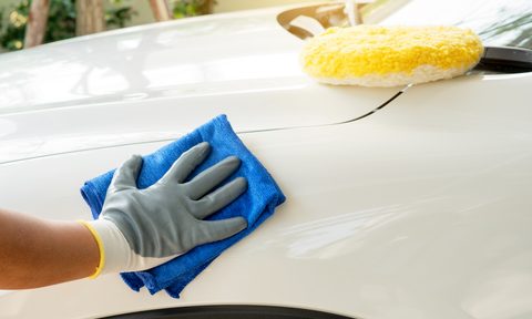 the best car lifts for your garage detailing  man holds microfiber in hand and polishes selective focus
