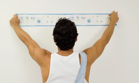 best wallpaper borders man putting up border  close rear view