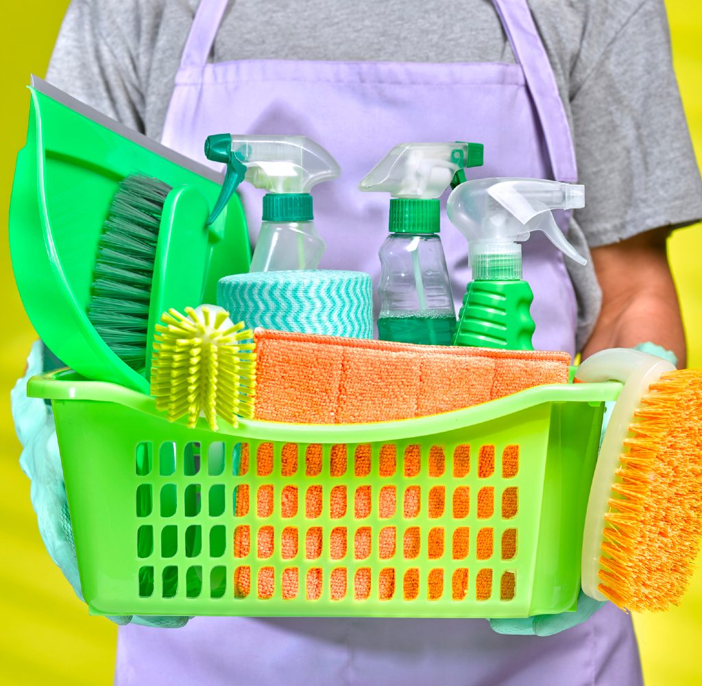 Person holding cleaning supplies