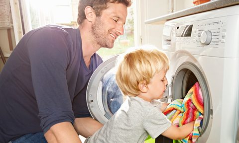 Parent and child doing laundry