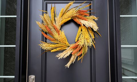 Black front door with autumn wreath