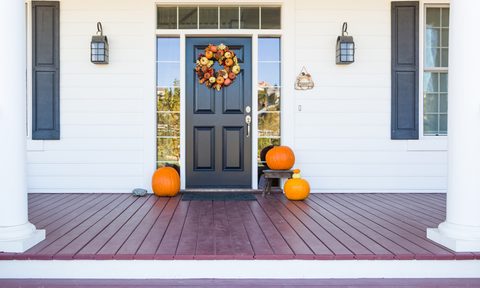 Fall front door decor with a wreath and pumpkins