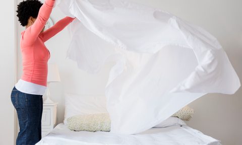 Woman making her bed