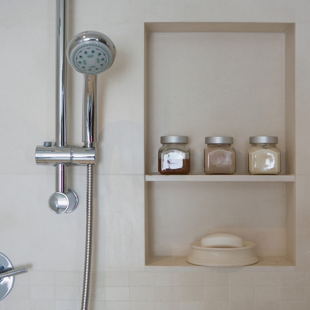 Shower head next to shower niche