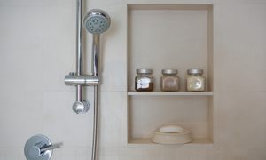 Shower head next to shower niche