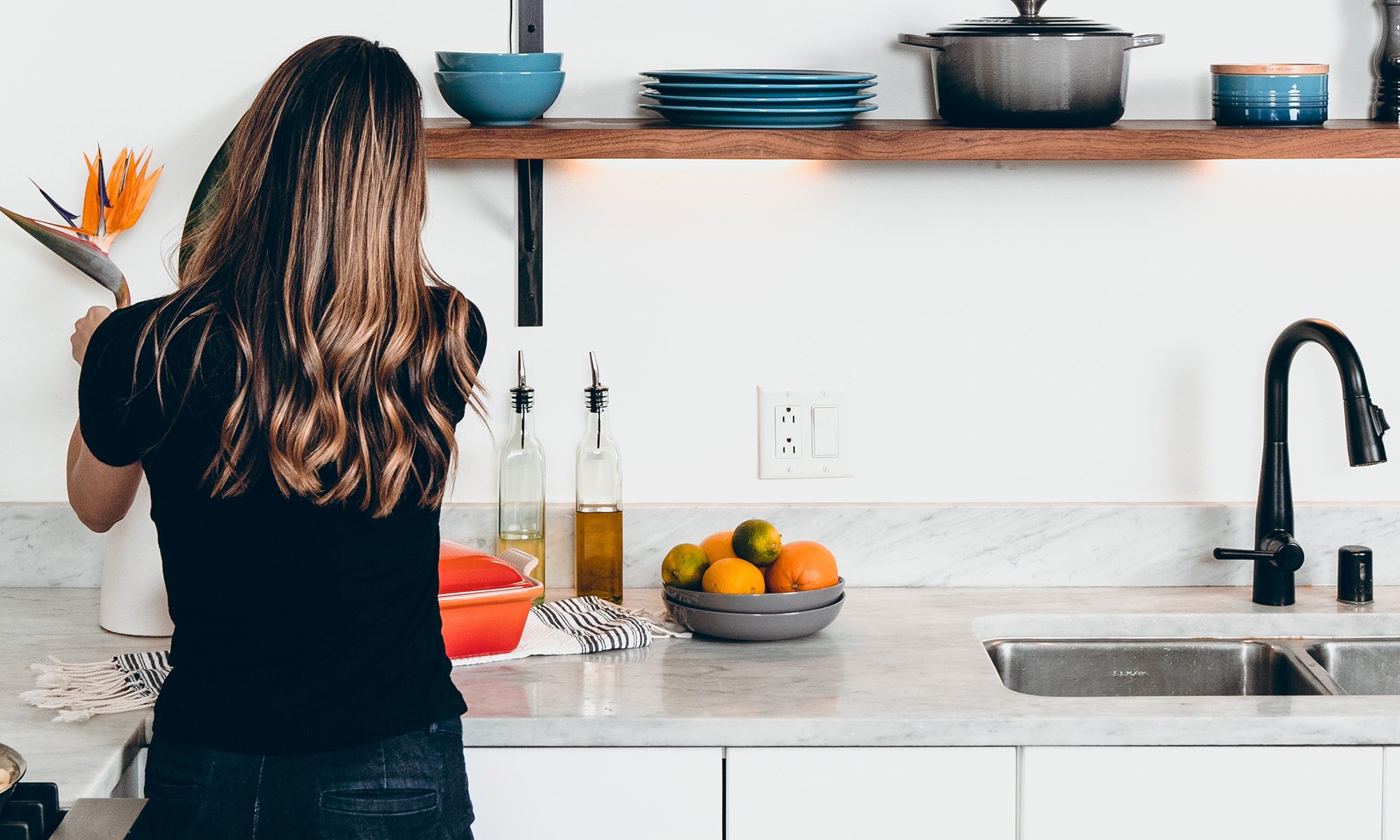 Women Placing Flowers on Kitchen Countertop