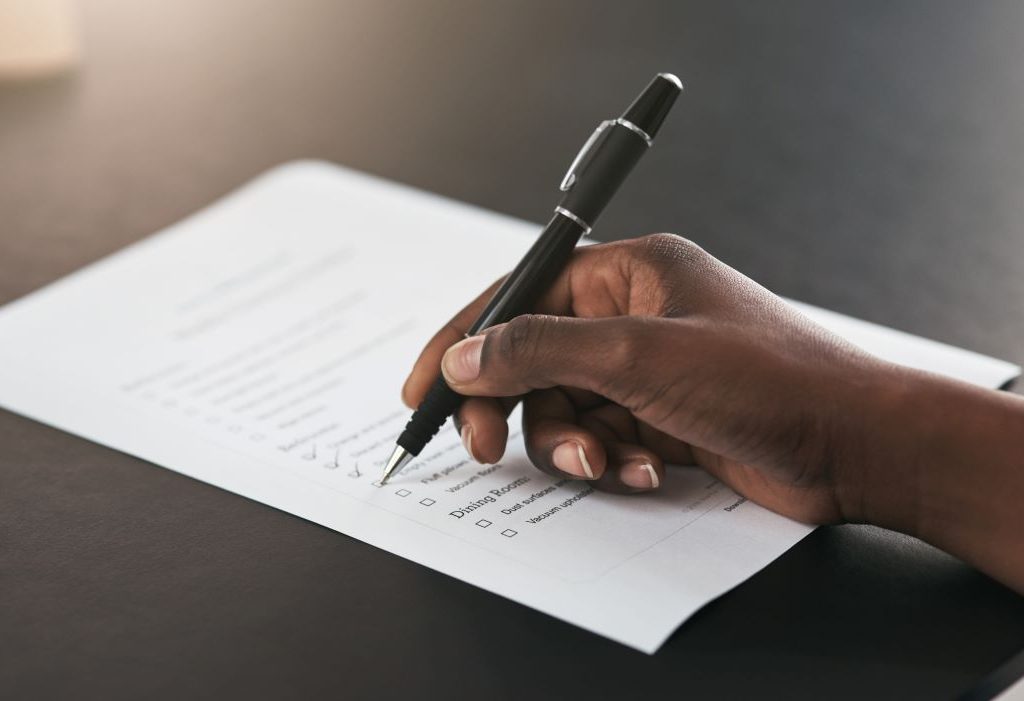 Person writing a list