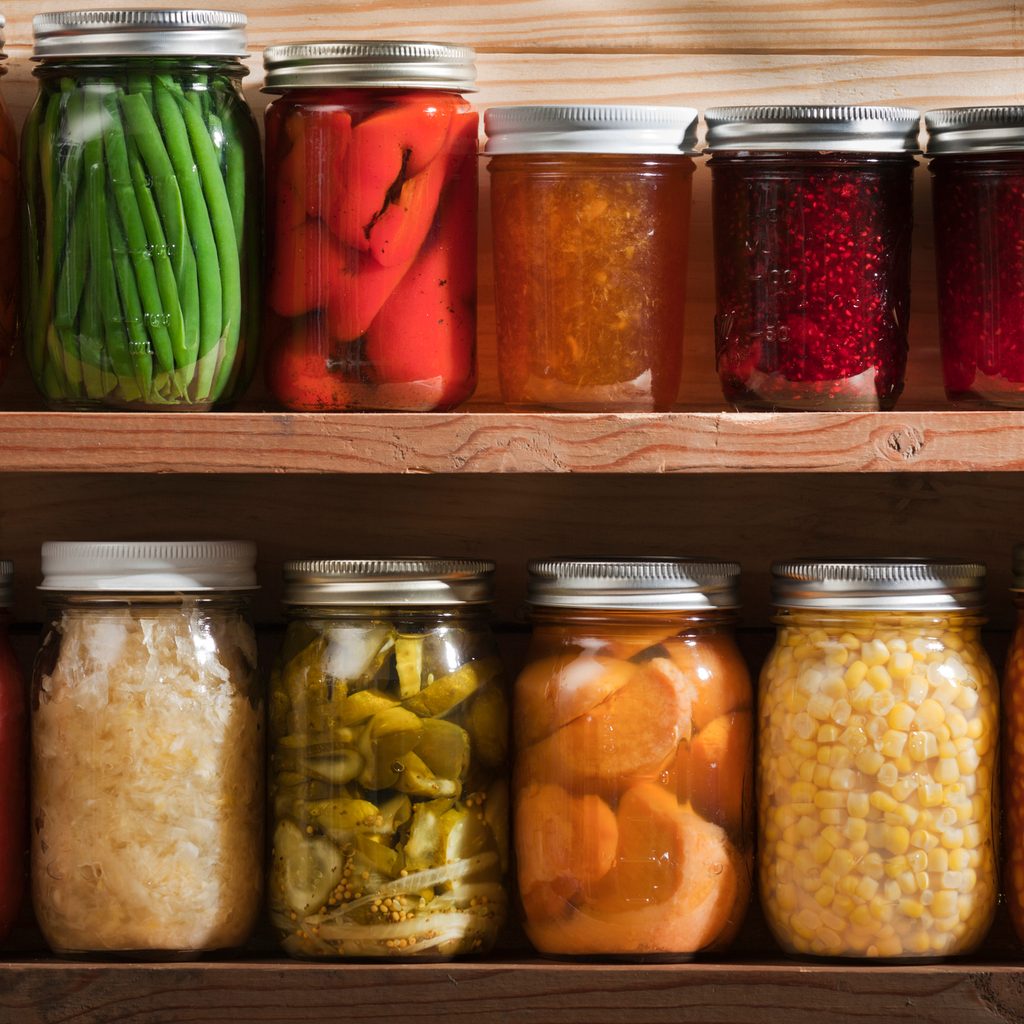 Home canning, preserving, pickling food stored on wooden storage shelves