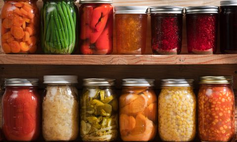 Home canning, preserving, pickling food stored on wooden storage shelves