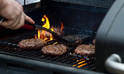 grilling burgers with flames