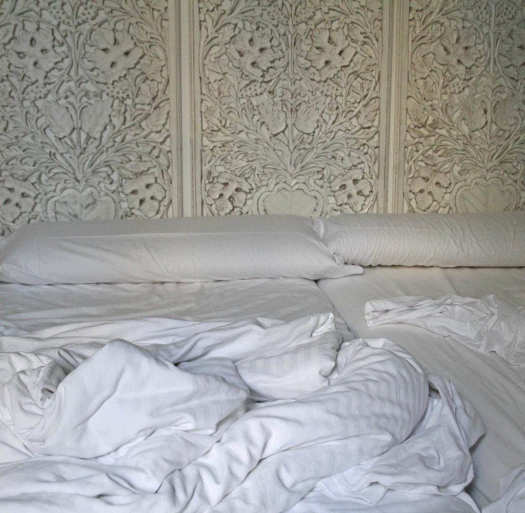 reclaimed-items-on-wall-behind-bed