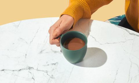 woman drinking coffee at table