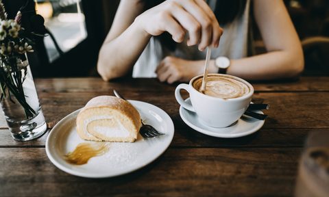 the best wood plastic and eco friendly coffee stirring sticks close up of young woman having a relaxing time enjoying cake in