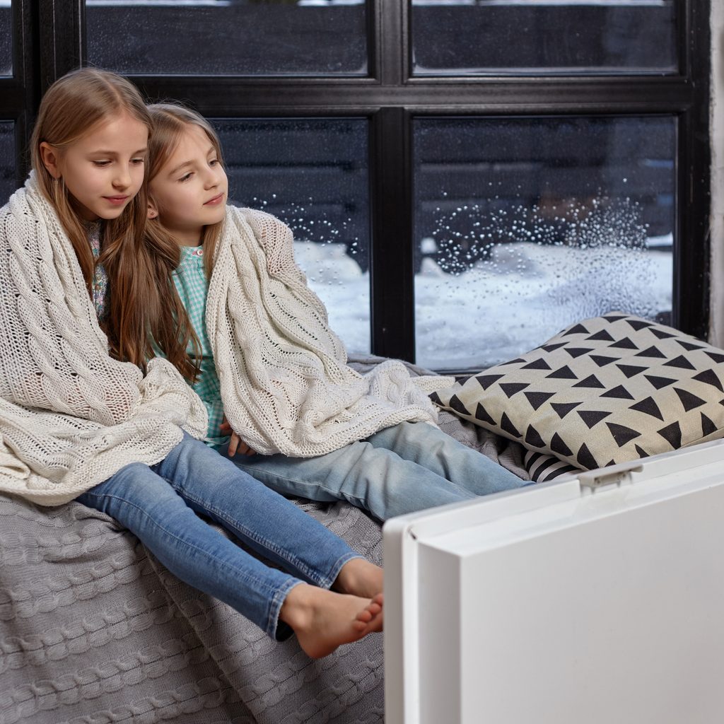 two children wrapped in blankets