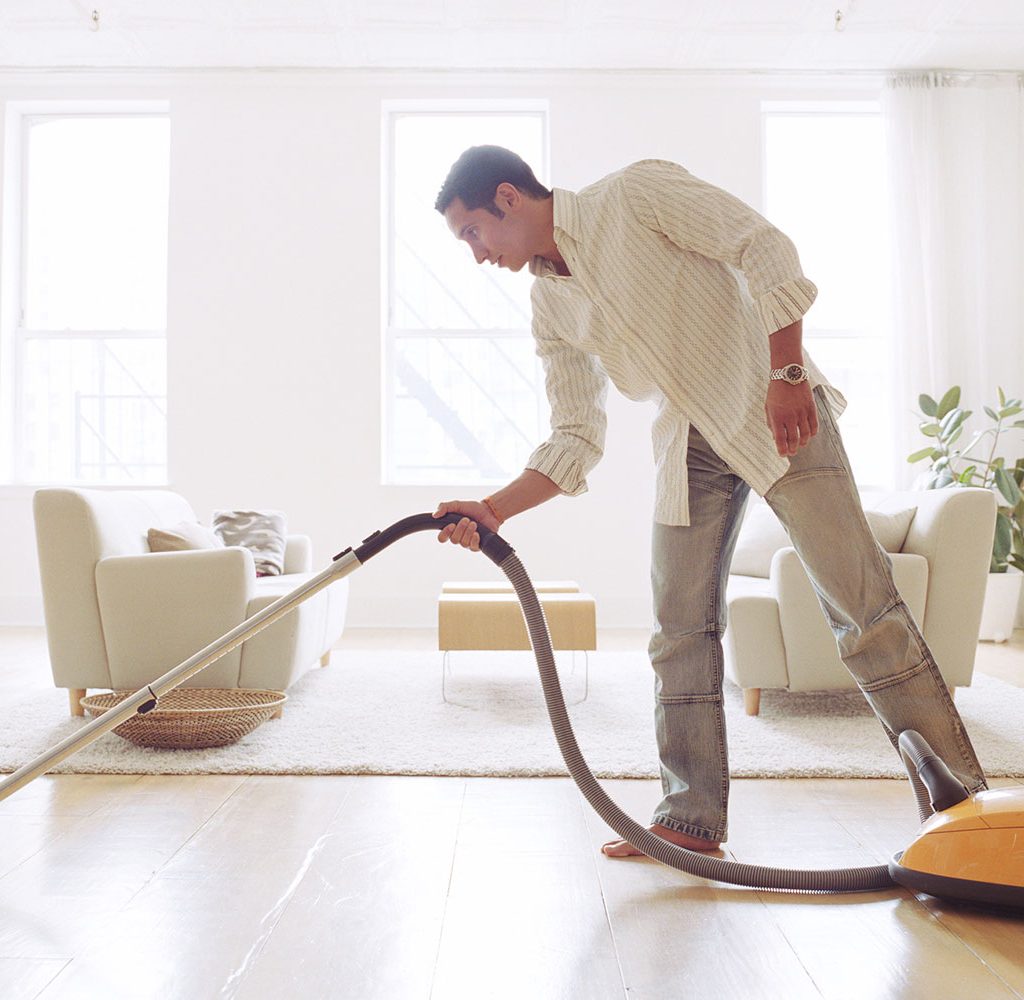 man cleaning living room