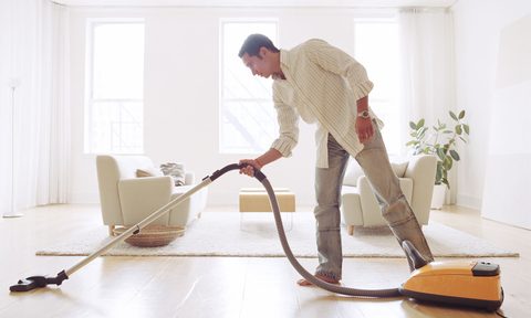 man cleaning living room