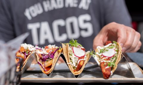 the best taco holders person eating tacos