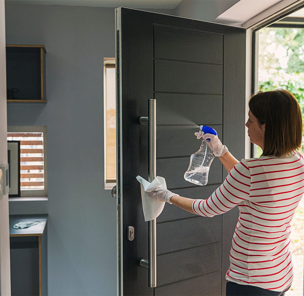 disinfecting and cleaning front door handle