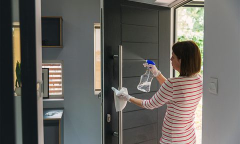 disinfecting and cleaning front door handle