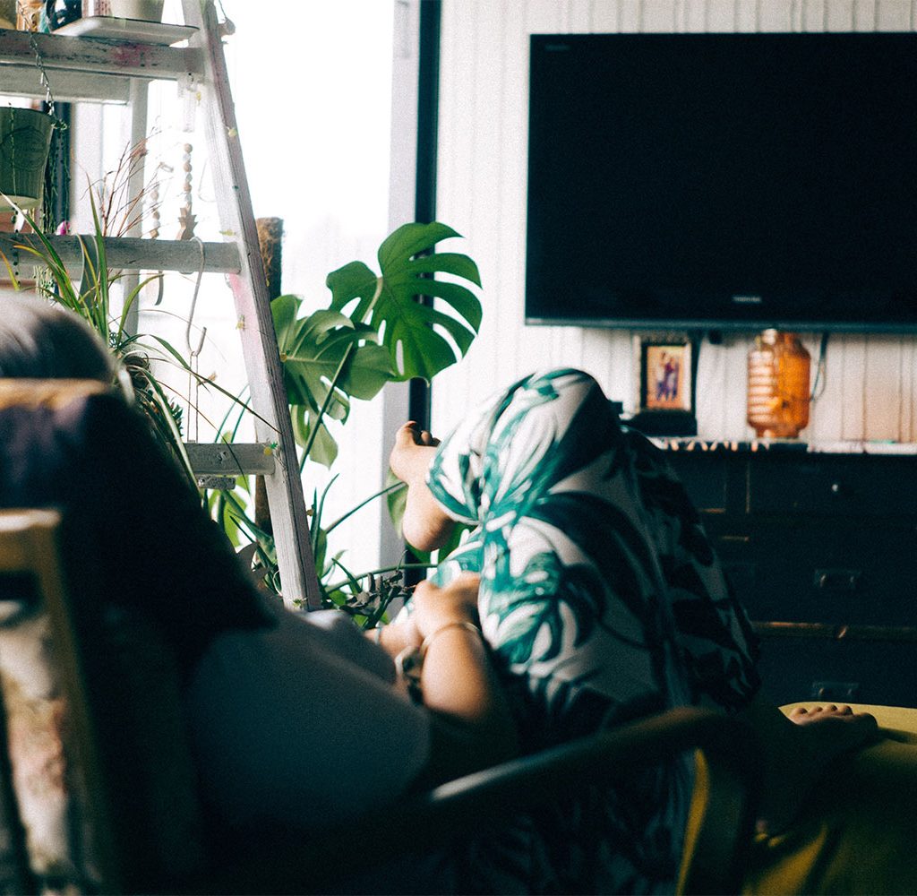 woman watching mounted tv