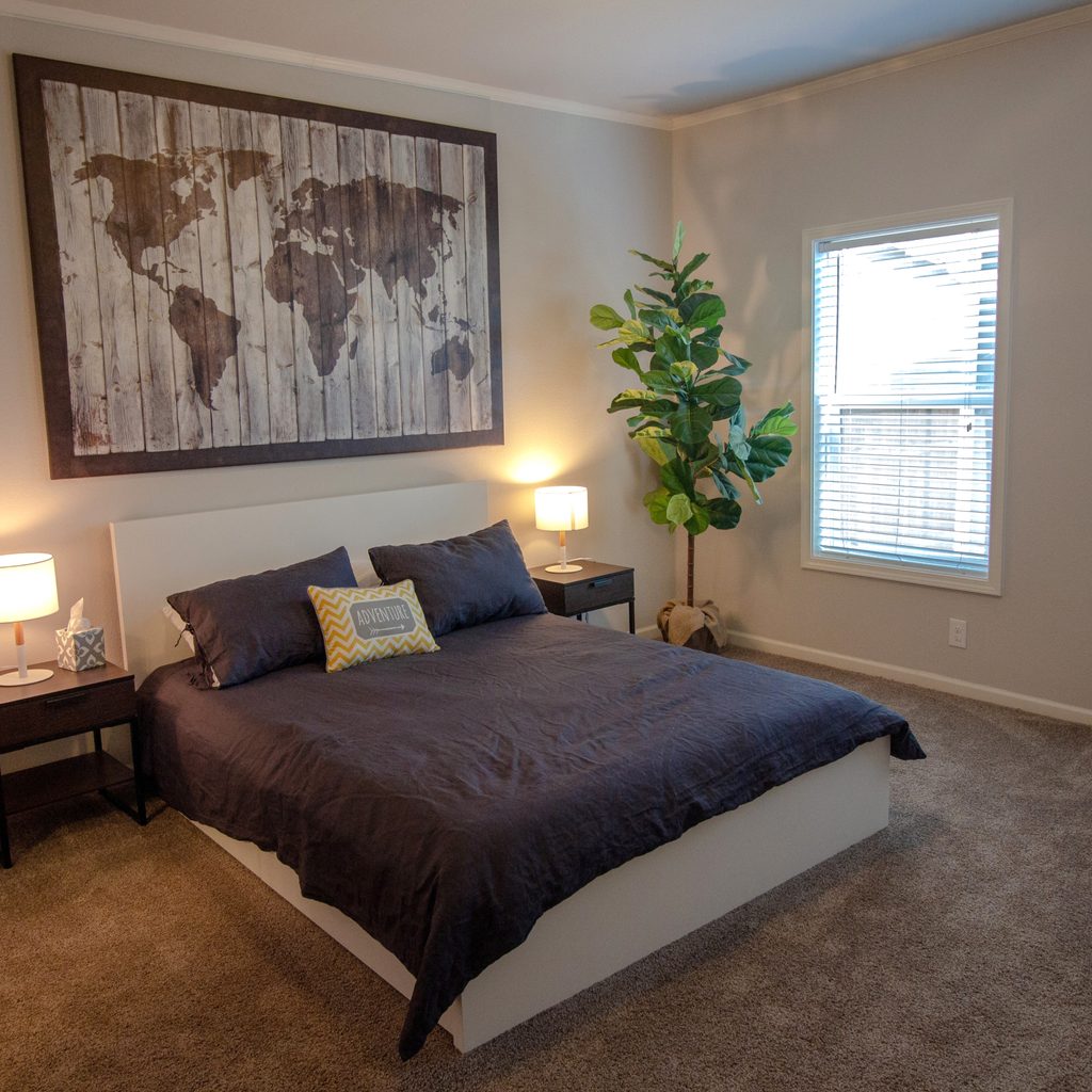 World map wall art above bed