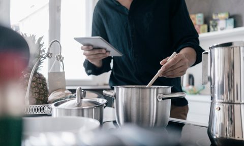 man cooking with pots and pans