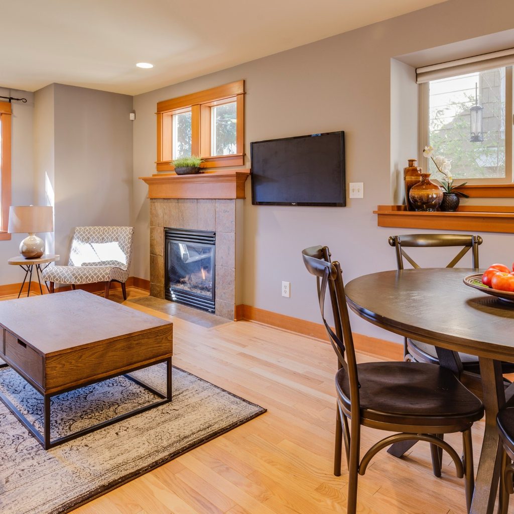 Living Room with Fireplace, Couch, and Dining Table