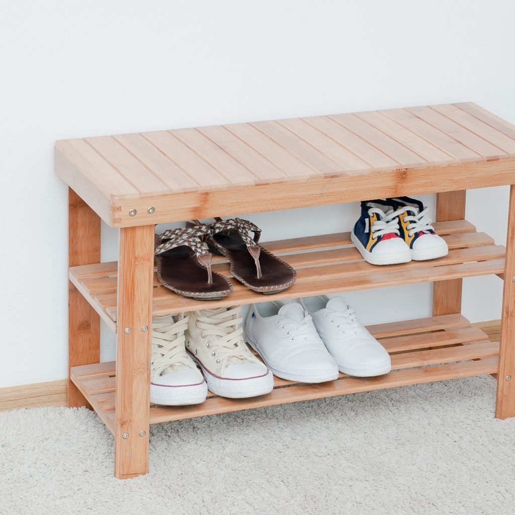 Wooden bench storing shoes