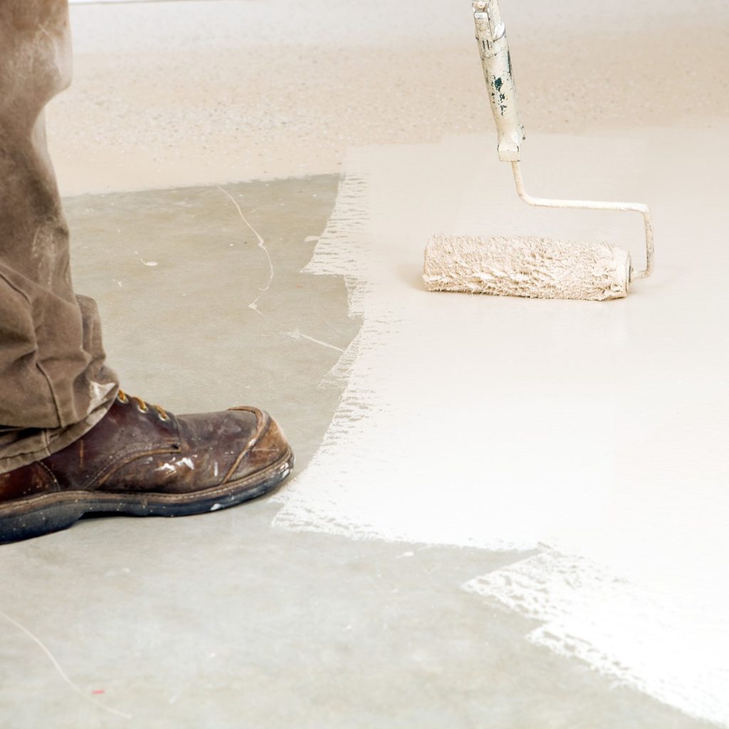 Person painting garage floor