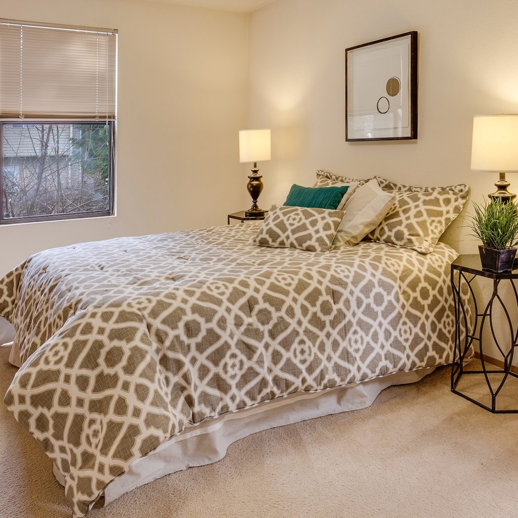 bedroom with neutral colors and table lamps