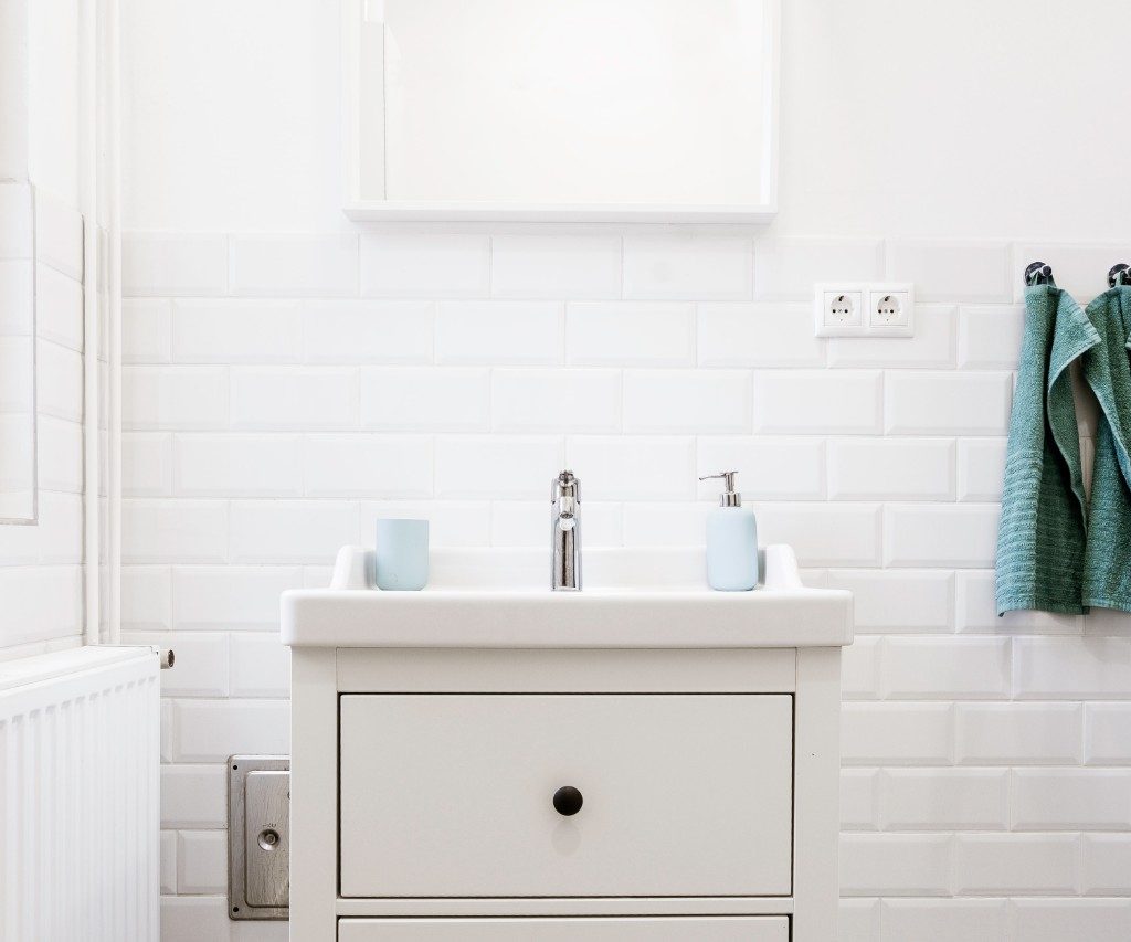 White bathroom sink with hanging towels