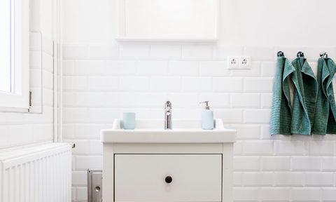 White bathroom sink with hanging towels