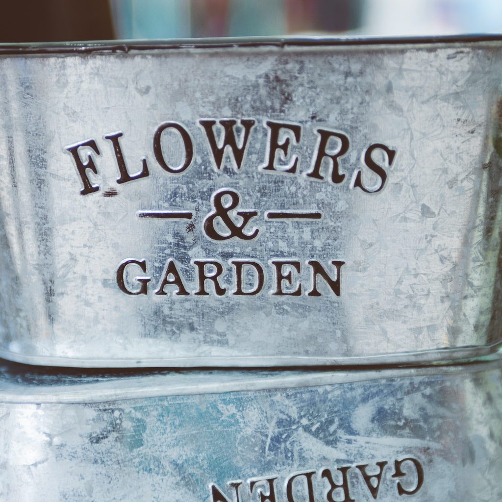 metal planter with words on front