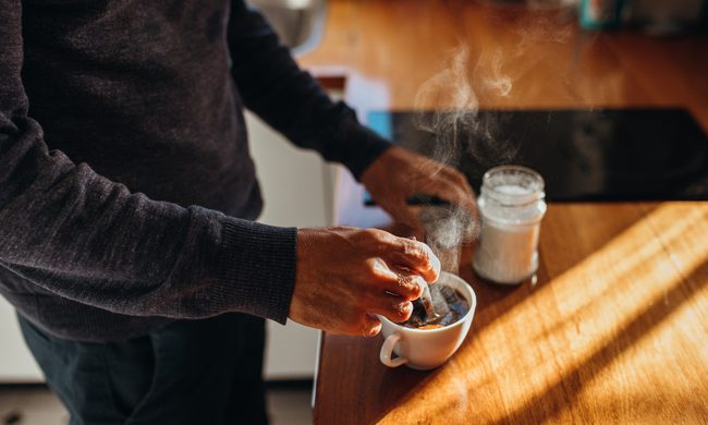 man preparing cup of coffee