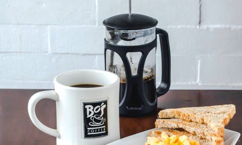 coffee, French press and plate of breakfast food