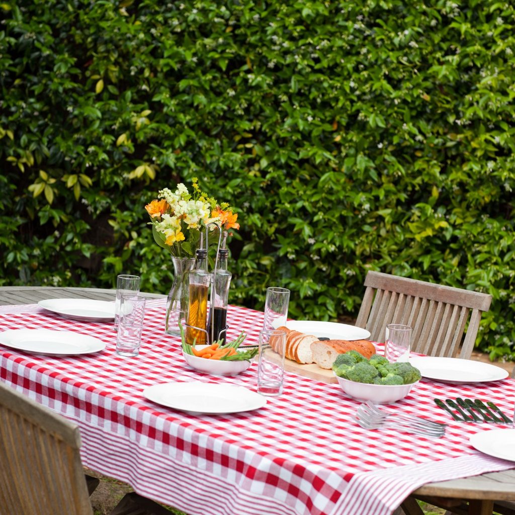 Wooden table with tablecloth on patio