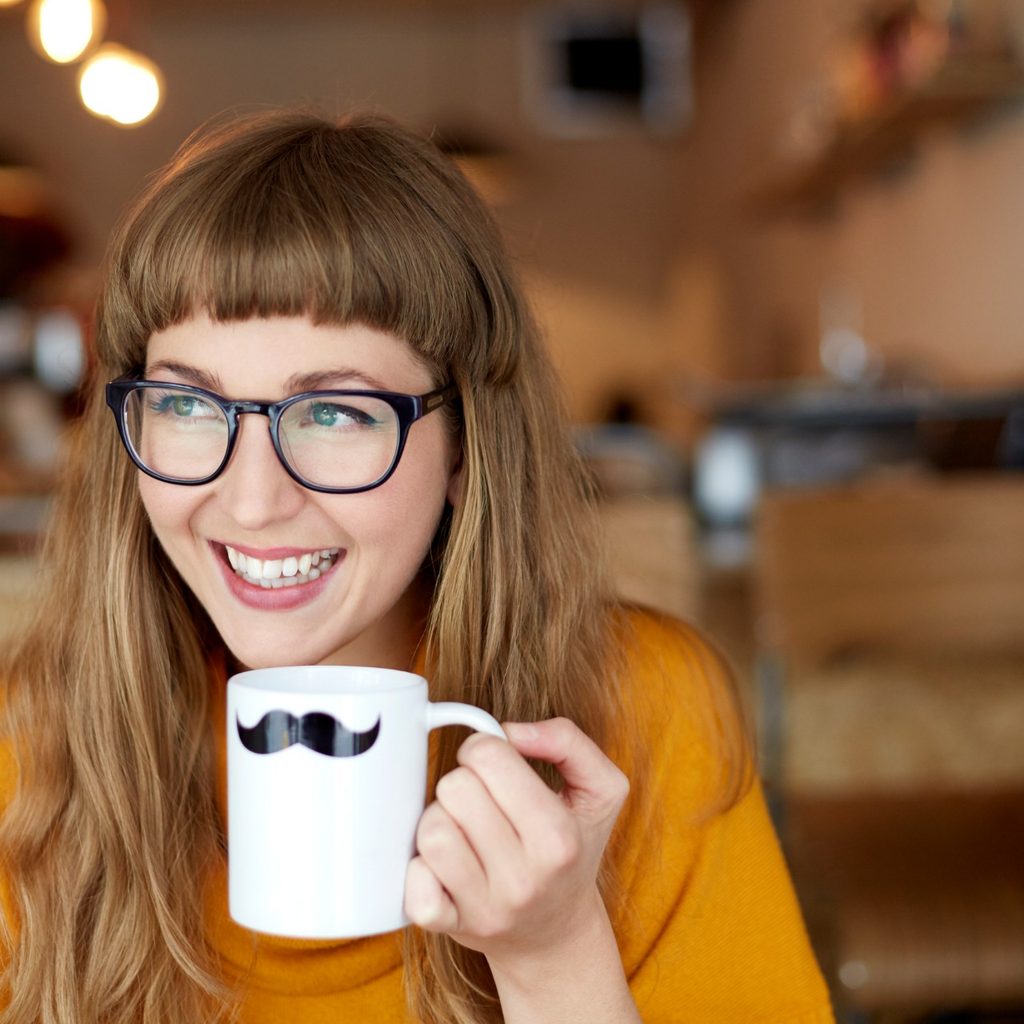 Smiling woman holding novelty mug