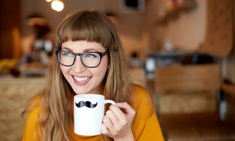 Smiling woman holding novelty mug