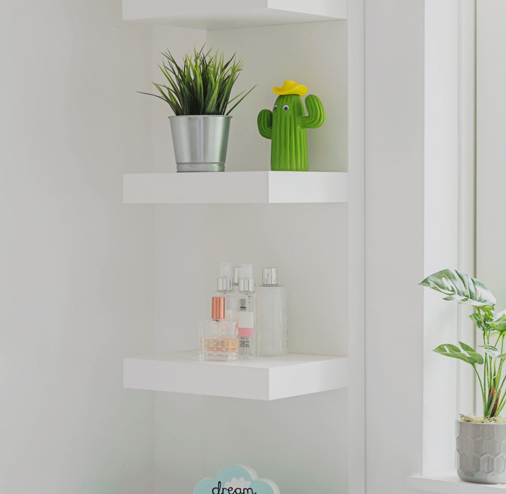 White floating shelves with plants on them
