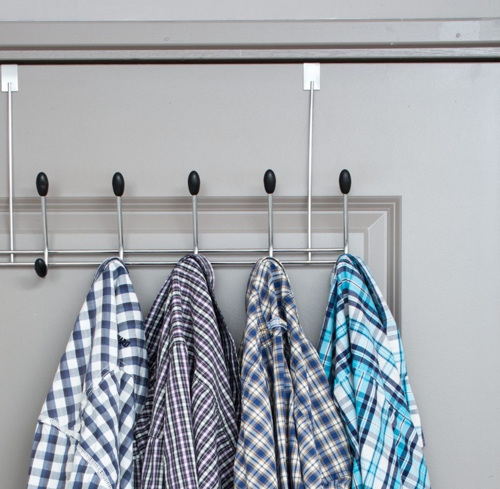Shirts hanging hooks on the back of a door