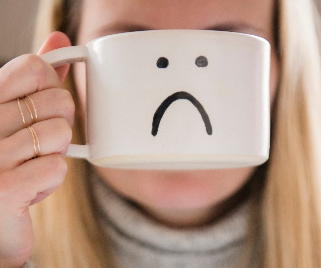 Woman holding novelty coffee mug