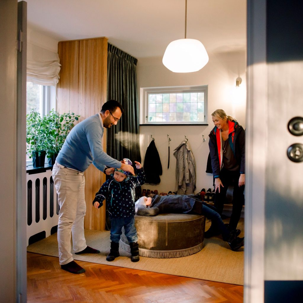 Mother and father putting coats on children